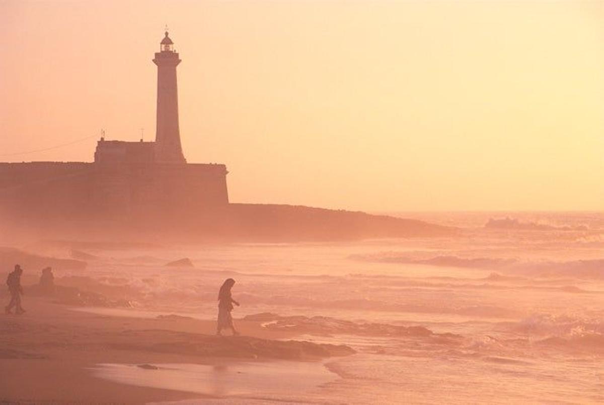 Atardecer en la playa de Rabat con el faro al fondo.