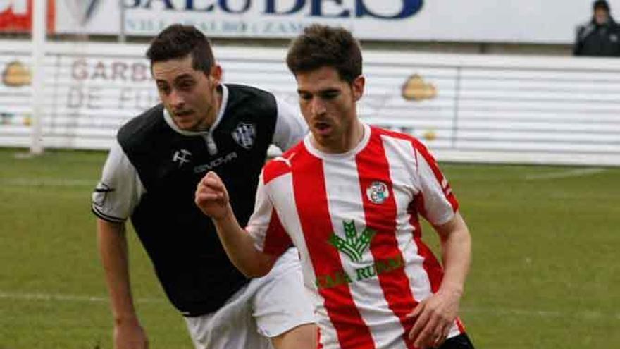 Aarón controla el balón ante un rival.