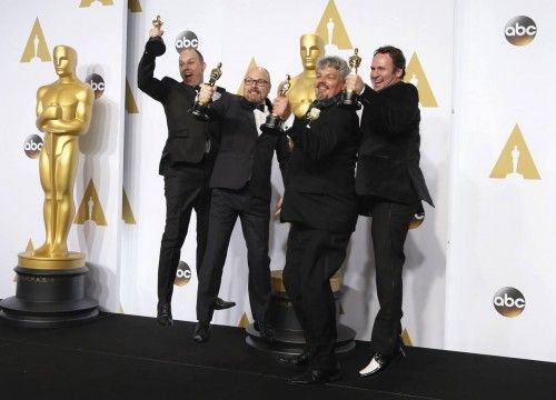 Winners of the award for best visual effects (L- R) Paul Franklin, Andrew Lockey, Ian Hunter, and Scott Fisher for "Interstellar" celebrate backstage during the 87th Academy Awards in Hollywood, California