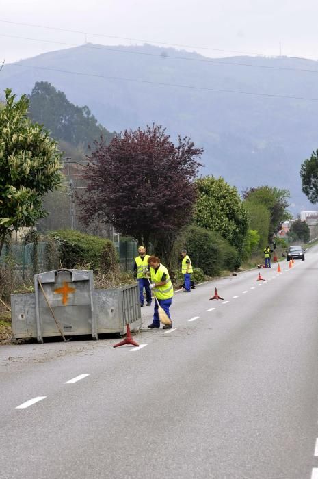 Trabajadores municipales en labores de desbroce en el paseo fluvial de Mieres con paso alternativo de vehículos