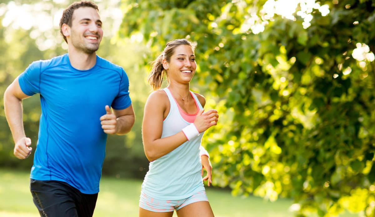Dos personas se ejercitan corriendo.
