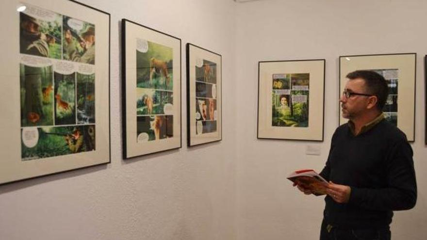 Manuel del Rivero mirando algunos de los originales que se exhiben en Colunga.