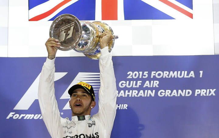 Mercedes Formula One driver Hamilton of Britain celebrates his victory on the podium with the winner's trophy after Bahrain's F1 Grand Prix at Bahrain International Circuit