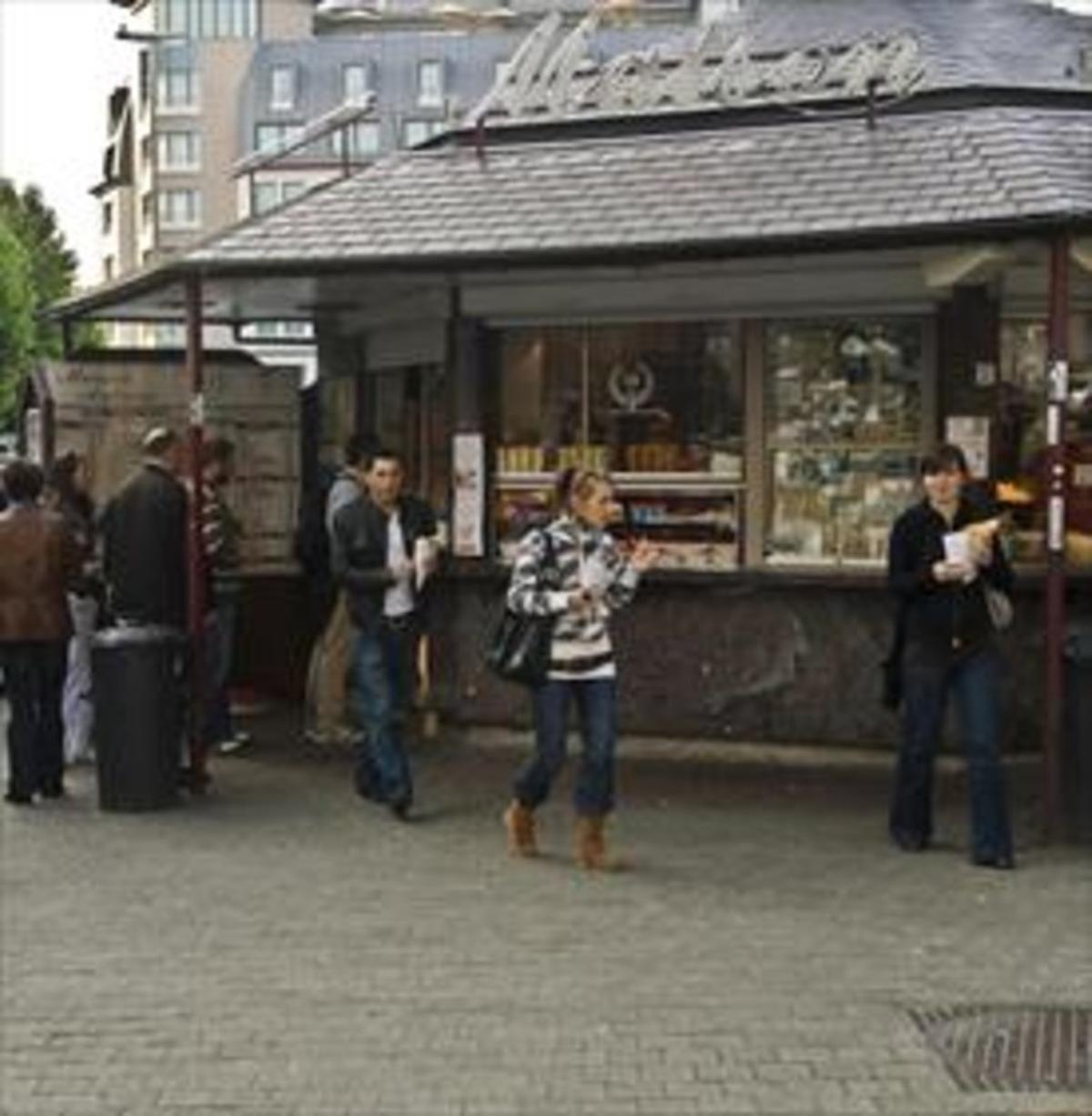 Tradición 8Tres jóvenes llevan bolsas de patatas fritas de un quiosco de Bruselas.