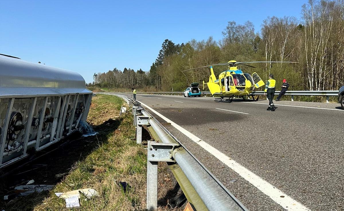 El camión cisterna volcado, izquierda, y el helicóptero tras aterrizar en la AP-9