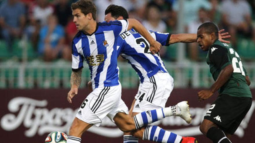 Iñigo Martínez (i) y Alberto de la Bella (c) pelean un balón.