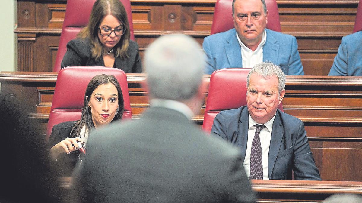 Nira Fierro y Sebastián Franquis (PSOE) escuchan la intervención de Fernando Clavijo (de espaldas), en el Pleno del Parlamento de Canarias.
