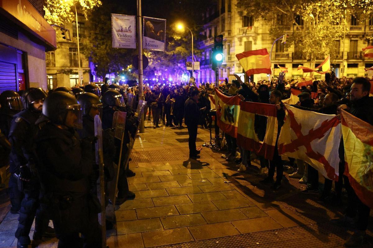 Manifestantes se encaran con la Policía en Ferraz este noviembre. Algunos llevan la bandera española con el símbolo monárquico recortado.