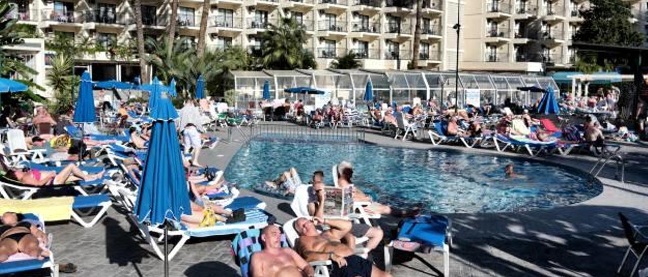 Turistas británicos toman el sol en la piscina de un hotel de la «zona guiri».