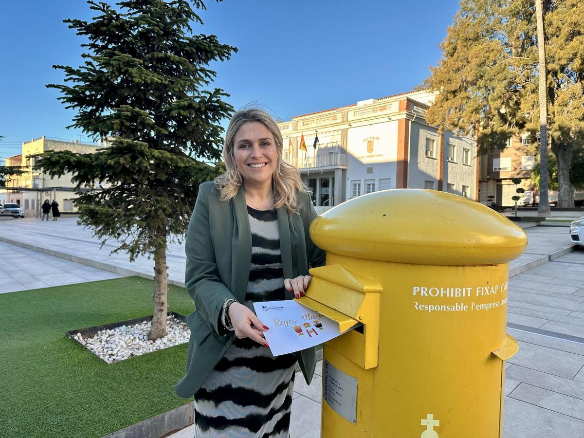 La alcaldesa de Vall d'Alba, Marta Barrachina, despositando su carta a los Reyes Magos en un buzón.