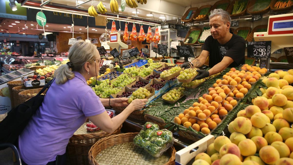 BARCELONA 10/08/2023 ECONOMIA Gente comprando alimentos en el Mercado de la Concepció fruta verdura uva parada de mercado alimentación IPC FOTO ELISENDA PONS