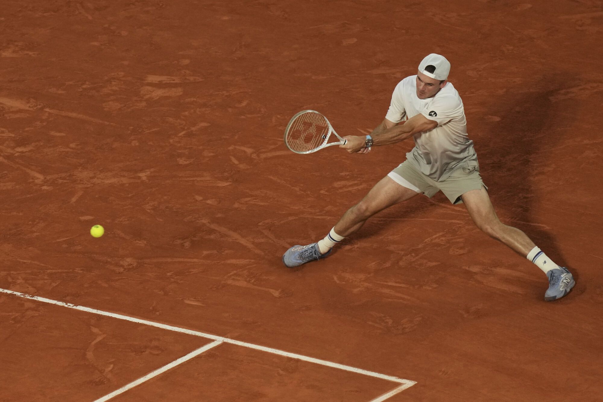 Tommy Paul of the U.S. plays a shot against Spain's Carlos Alcaraz during their quarterfinal match of the French Tennis Open at the Roland-Garros stadium in Paris, Tuesday, June 3, 2025. (AP Photo/Thibault Camus)