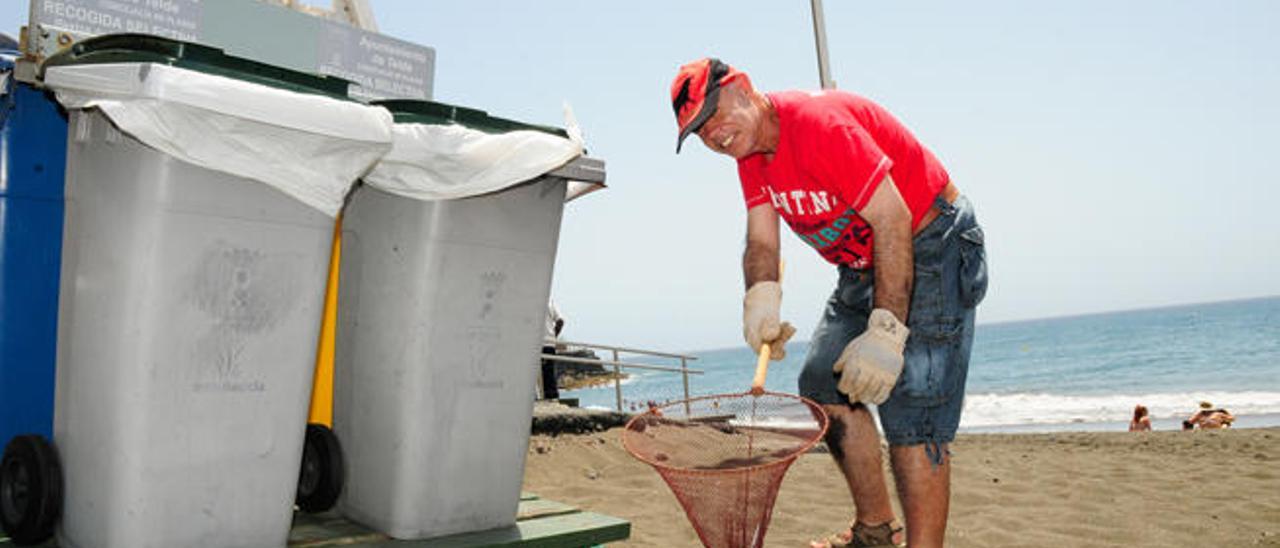 Un voluntario recoge basura con la mariposa, ayer, en La Garita.