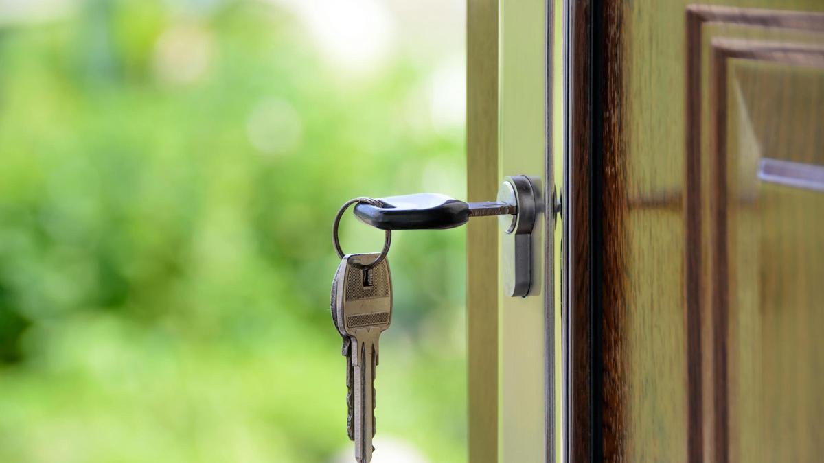 Una llave colgando de la puerta de casa