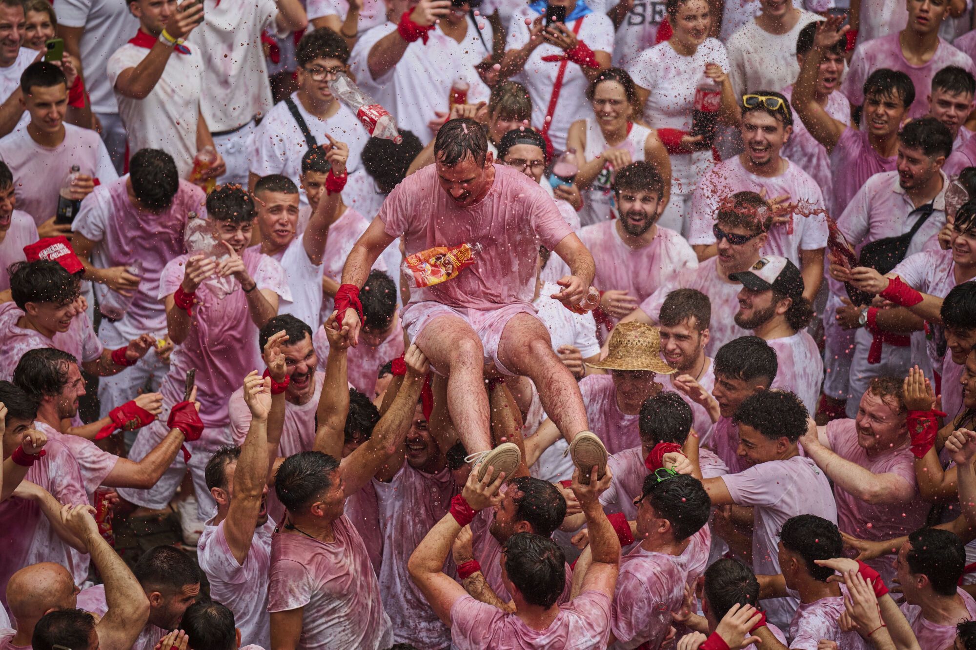 Revelers pack the main square during the start of nine days of uninterrupted partying in Pamplona's famed running-of-the-bulls festival in Pamplona, Spain, Sunday, July 6, 2025. (AP Photo/Miguel Oses). EDITORIAL USE ONLY/ONLY ITALY AND SPAIN
