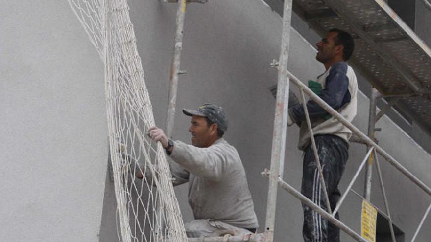 Nouvinguts treballant en una construcció a Sant Feliu de Guíxols.