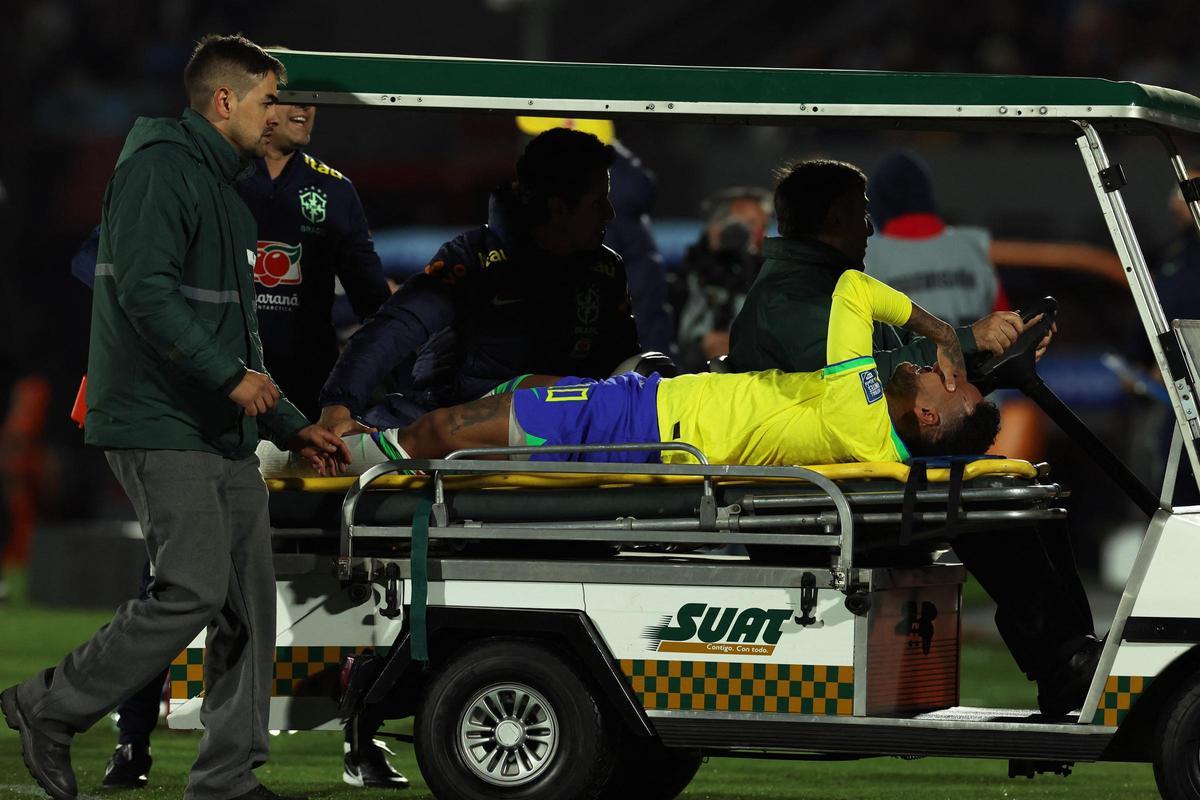 Neymar sale del campo en camilla tras la grave lesión que sufrió contra Uruguay.