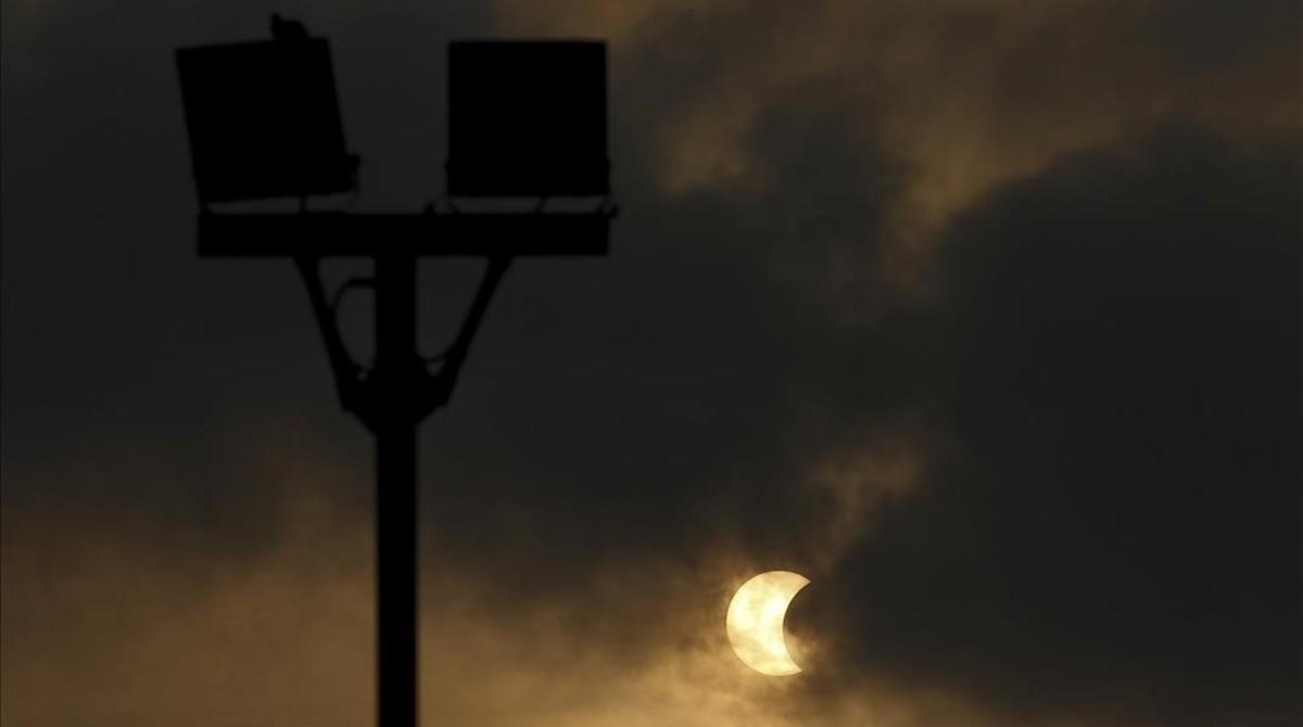 jcortadellas33104379 a partial solar eclipse is seen through clouds in 160309102156