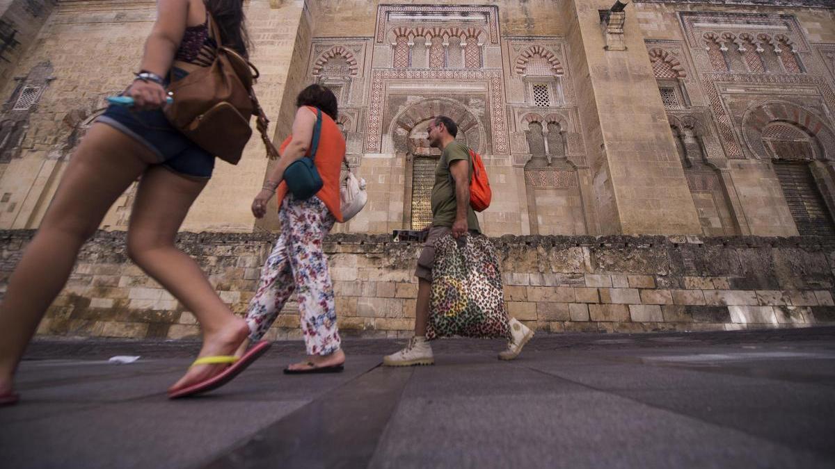 Turistas pasean frente a la puerta de San José, situada en el muro oriental de la Mezquita-Catedral de Córdoba.