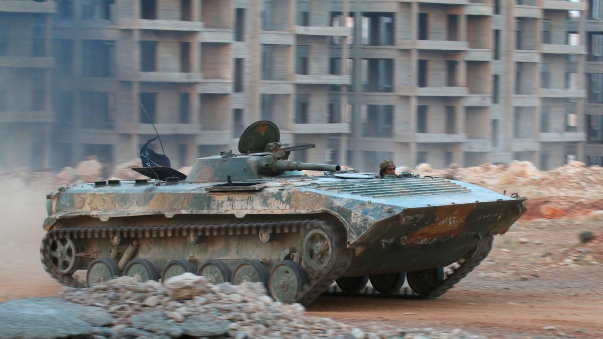 A file photo shows a fighter of the Syrian Islamist rebel group Jabhat Fateh al-Sham riding in an armored vehicle in the 1070 Apartment Project area in southwestern Aleppo