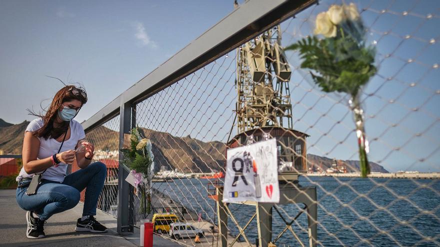 Una mujer deja un recuerdo para Olivia y Anna en el puerto de Santa Cruz de Tenerife. | | ANDRÉS GUTIÉRREZ