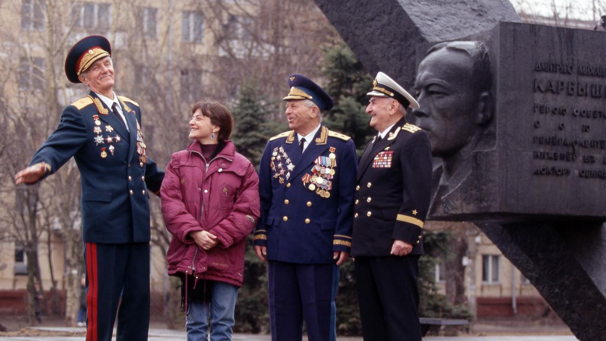 Olga Merino, con tres generales soviéticos, uno por cada rama del Ejército, veteranos de la segunda guerra mundial, frente al monumento al teniente general Dimitri Karbishev, en 1995.