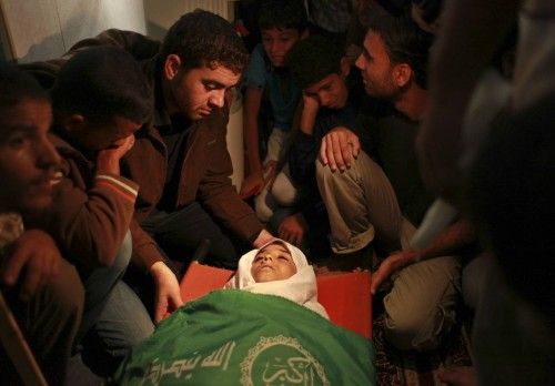 Palestinians mourn next the body of Abu Dagah, who was killed by gunfire from Israeli forces, during his funeral in Khan Younis in the southern Gaza Strip