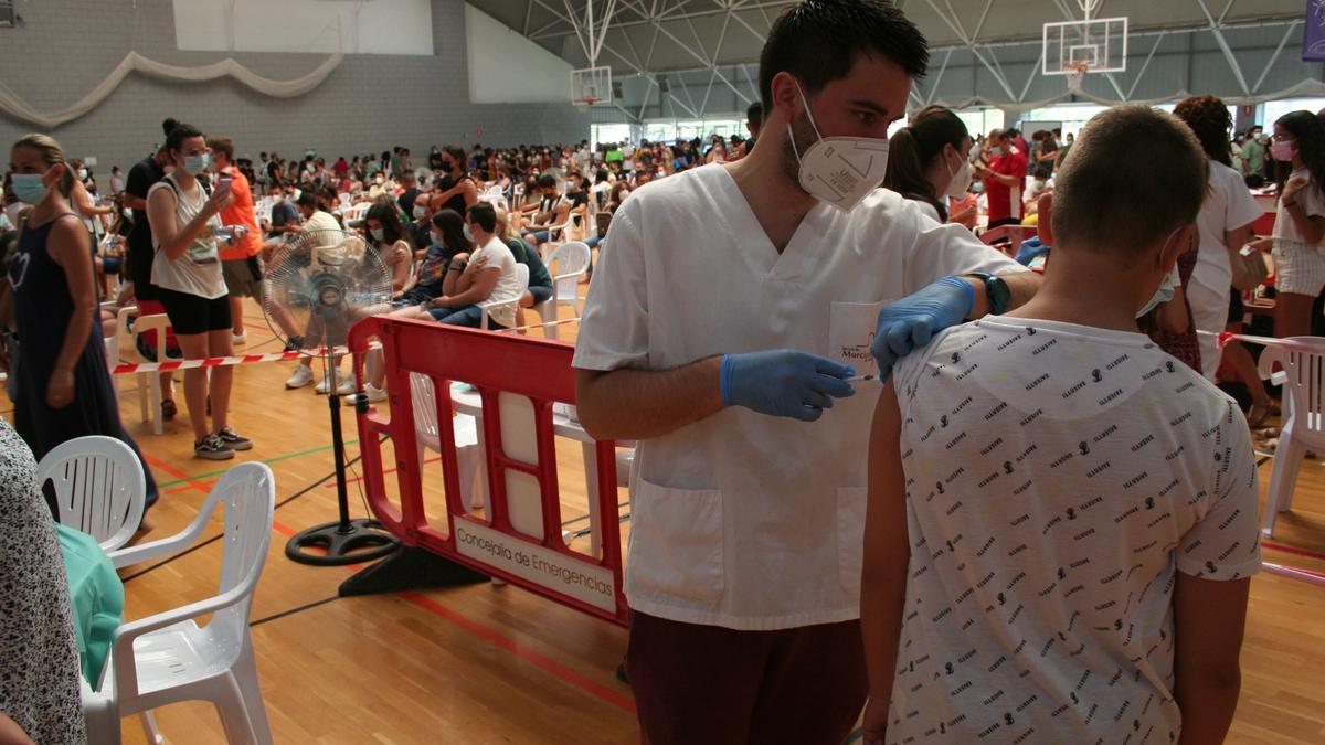 Un enfermero vacuna a un niño en el Felipe VI.