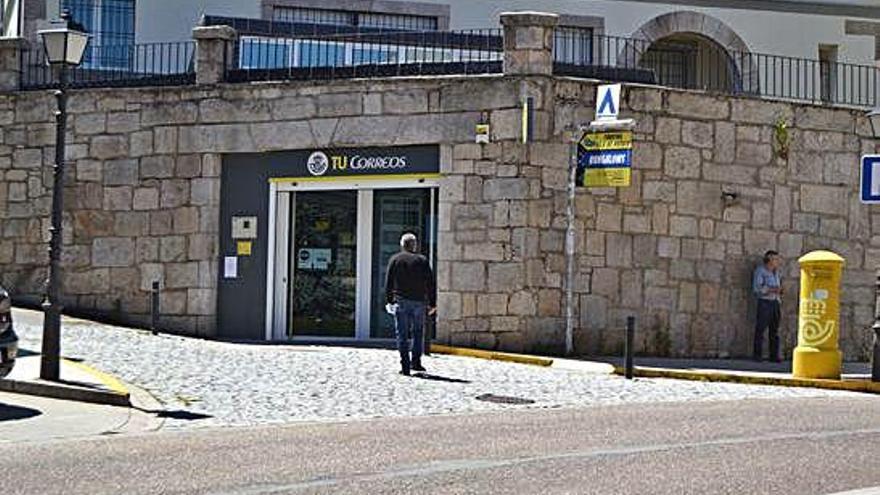 Una persona se dirige al edificio de Correos en Puebla de Sanabria.