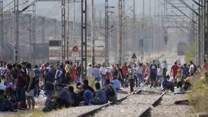 Refugiados esperan para cruzar la frontera entre Macedonia y Grecia.