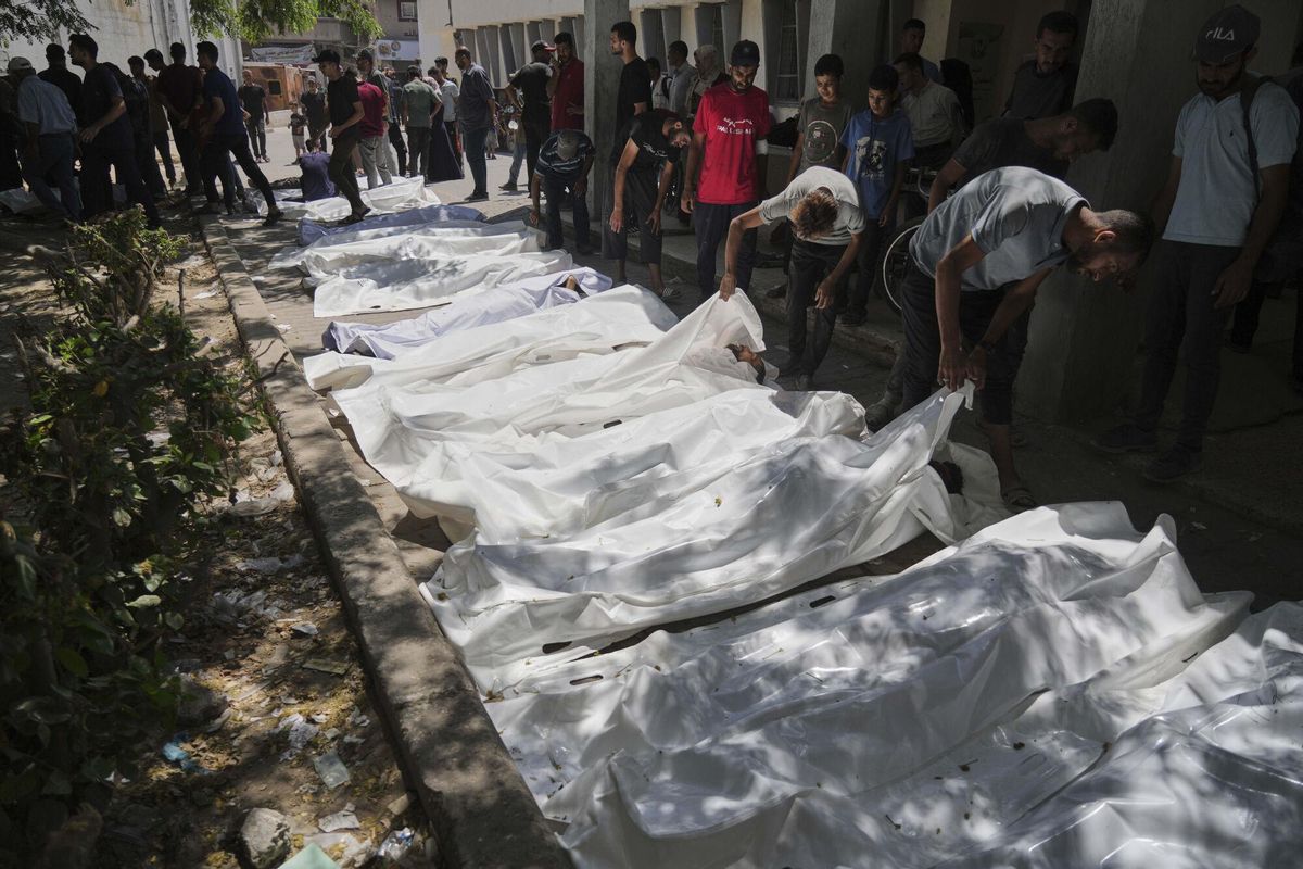 The bodies of Palestinians who were killed while attempting to access aid trucks entering northern Gaza through the Zikim crossing with Israel are brought to a clinic in Gaza City, Sunday, July 20, 2025. (AP Photo/Jehad Alshrafi). EDITORIAL USE ONLY / ONLY ITALY AND SPAIN