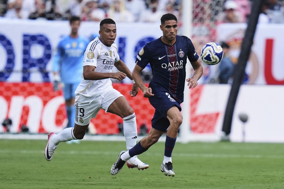 Paris Saint-Germains Achraf Hakimi (2) and Real Madrids Kylian Mbappe (9) chase the ball during the Club World Cup semifinal soccer match between PSG and Real Madrid in East Rutherford, N.J., Wednesday, July 9, 2025. (AP Photo/Seth Wenig)