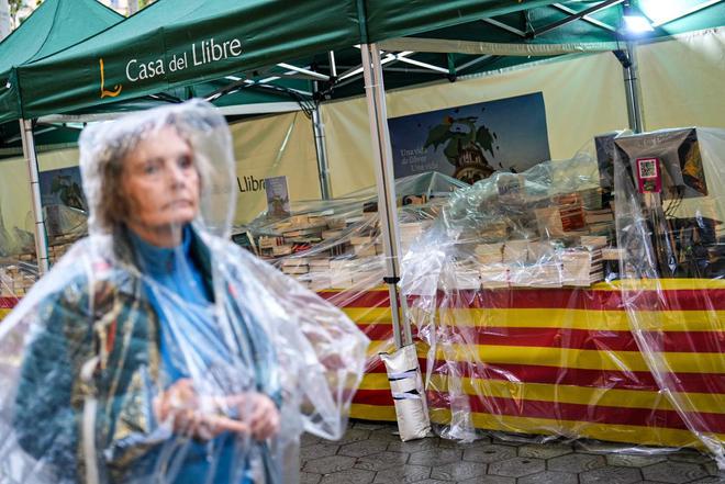 Los stans armados y peatones se protegen de la lluvia en Paseo de Gracia