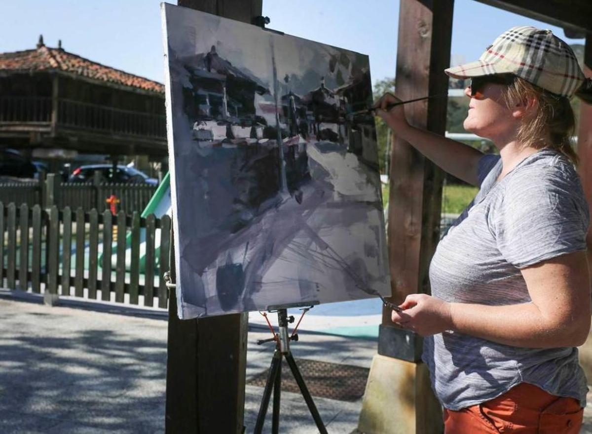 Pintor y caballete con hórreo al fondo