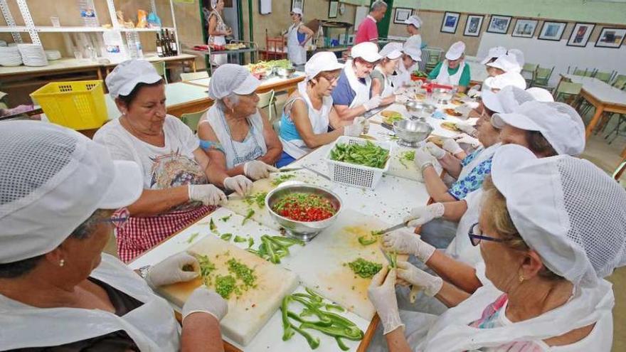 Voluntarias de la Asociación de Mulleres, ayer, preparando las salsas. // Marta G. Brea