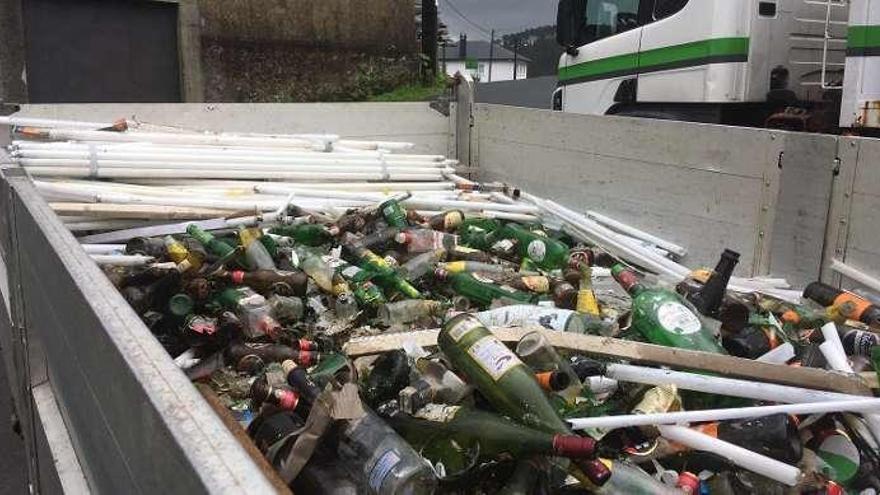 Decenas de barras fluorescentes, quedaron depositadas junto a las botellas y envases de vidrio del contenedor de Cira.