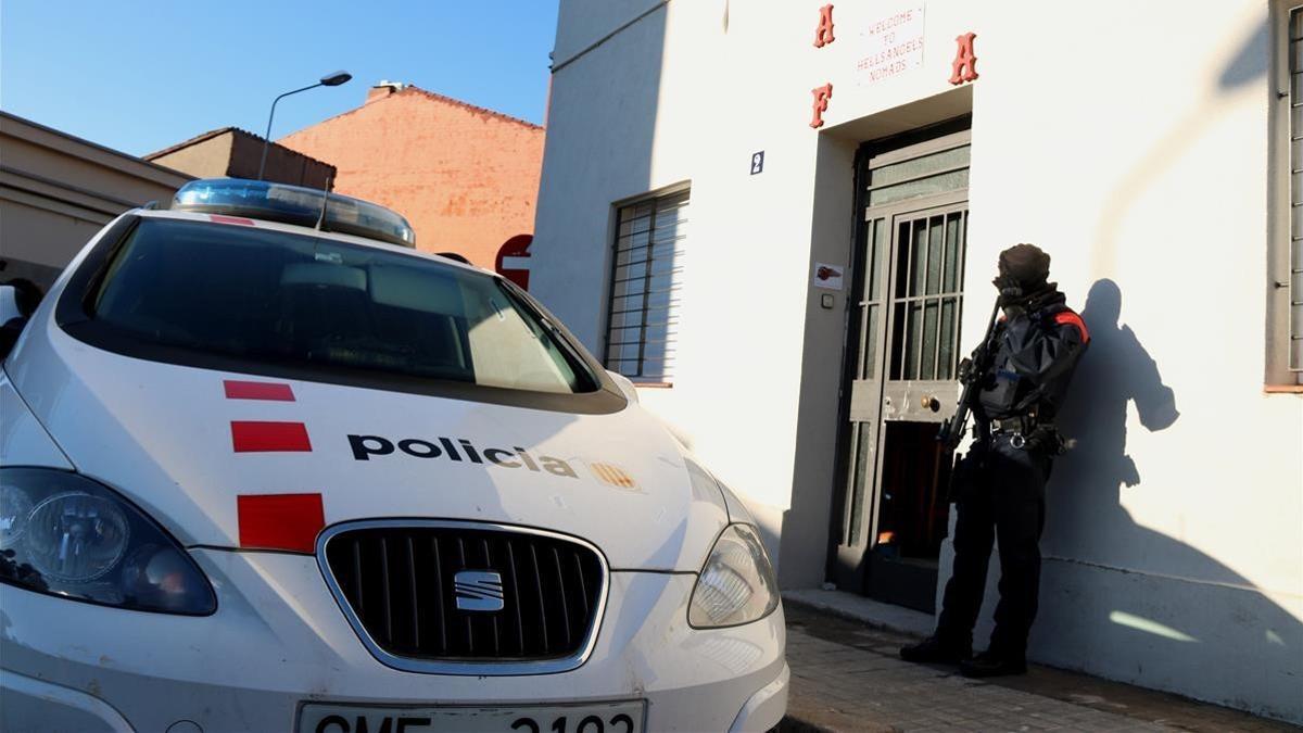 Un agente de los Mossos custodia la entrada a la sede de Los Ángeles del Infierno en Sabadell.