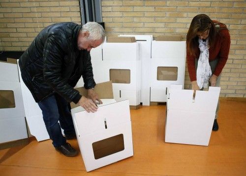 Volunteers set up ballots boxes in a polling place for the 9N consultation in Sant Feliu de Llobregat, near Barcelona