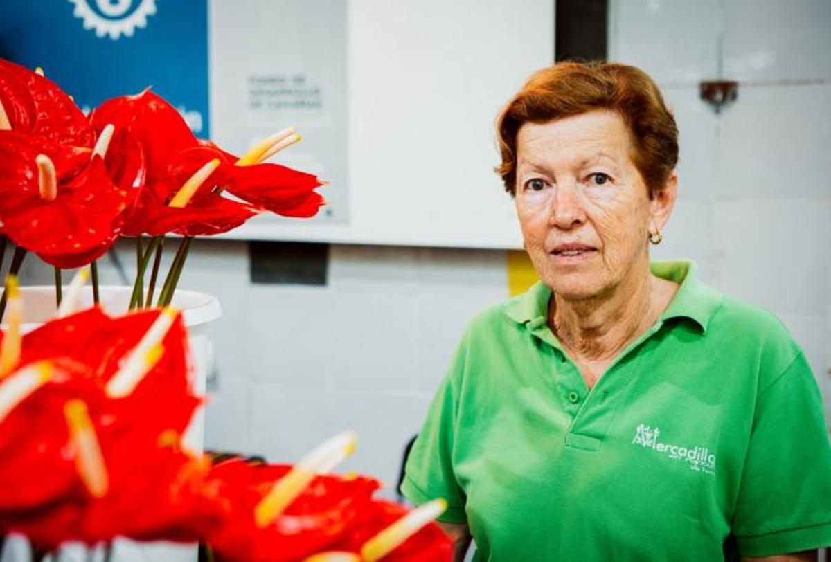 Miguelina, una de las socias de mercadillo en su puesto de flores