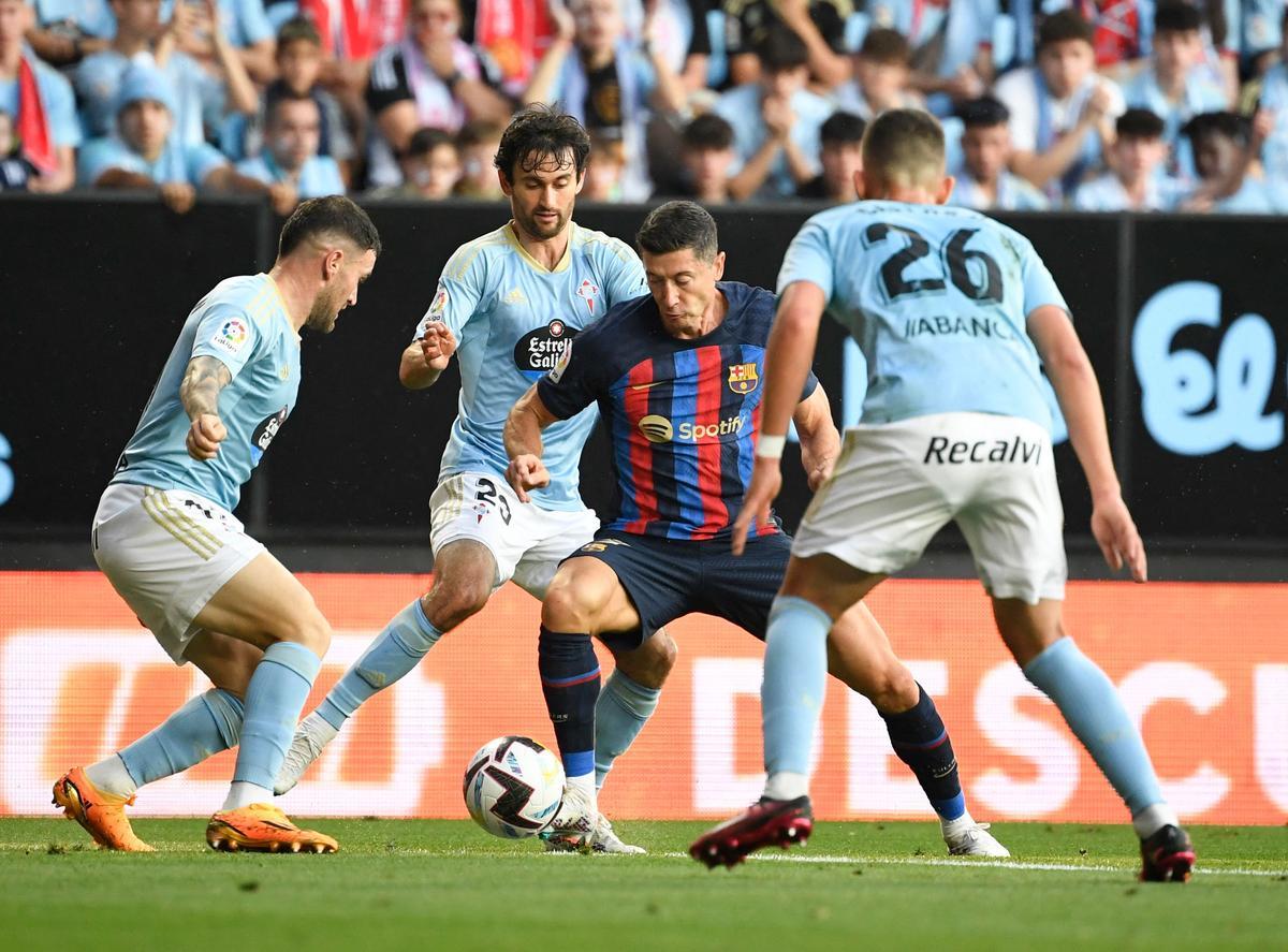 El delantero polaco del Barcelona, ​​Robert Lewandowski con los defensores del Celta Vigo.