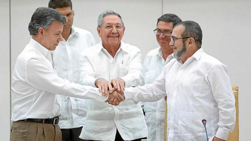 Santos i el líder de les FARC (amb barba) encaixen les mans