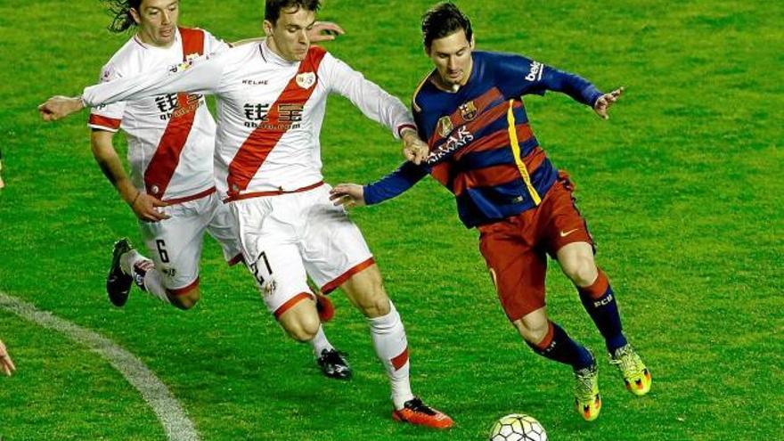 Leo Messi s&#039;escapa de Llorente i Iturra, que després serien expulsats, en una acció del partit a Vallecas