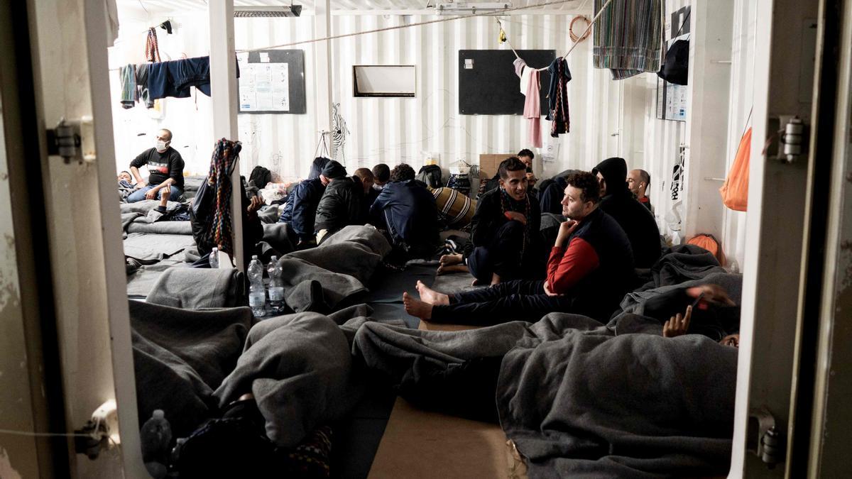 Migrantes descansando a bordo del barco de rescate &quot;Ocean Viking&quot; de la organización humanitaria marítima europea &quot;SOS Mediterranee&quot; en aguas internacionales en el golfo de Catania