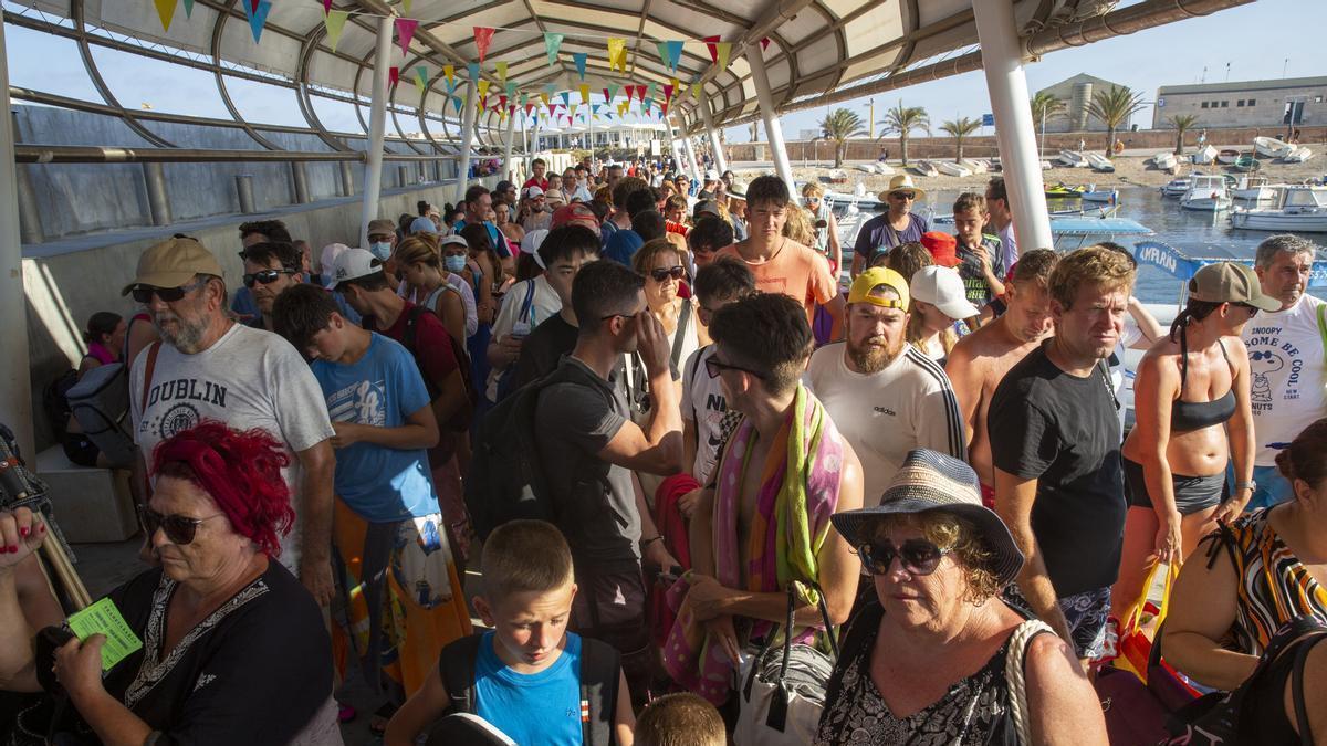 Cientos de turistas se agolpan en el puerto a la espera de los barcos para volver a la península, en una imagen de este verano