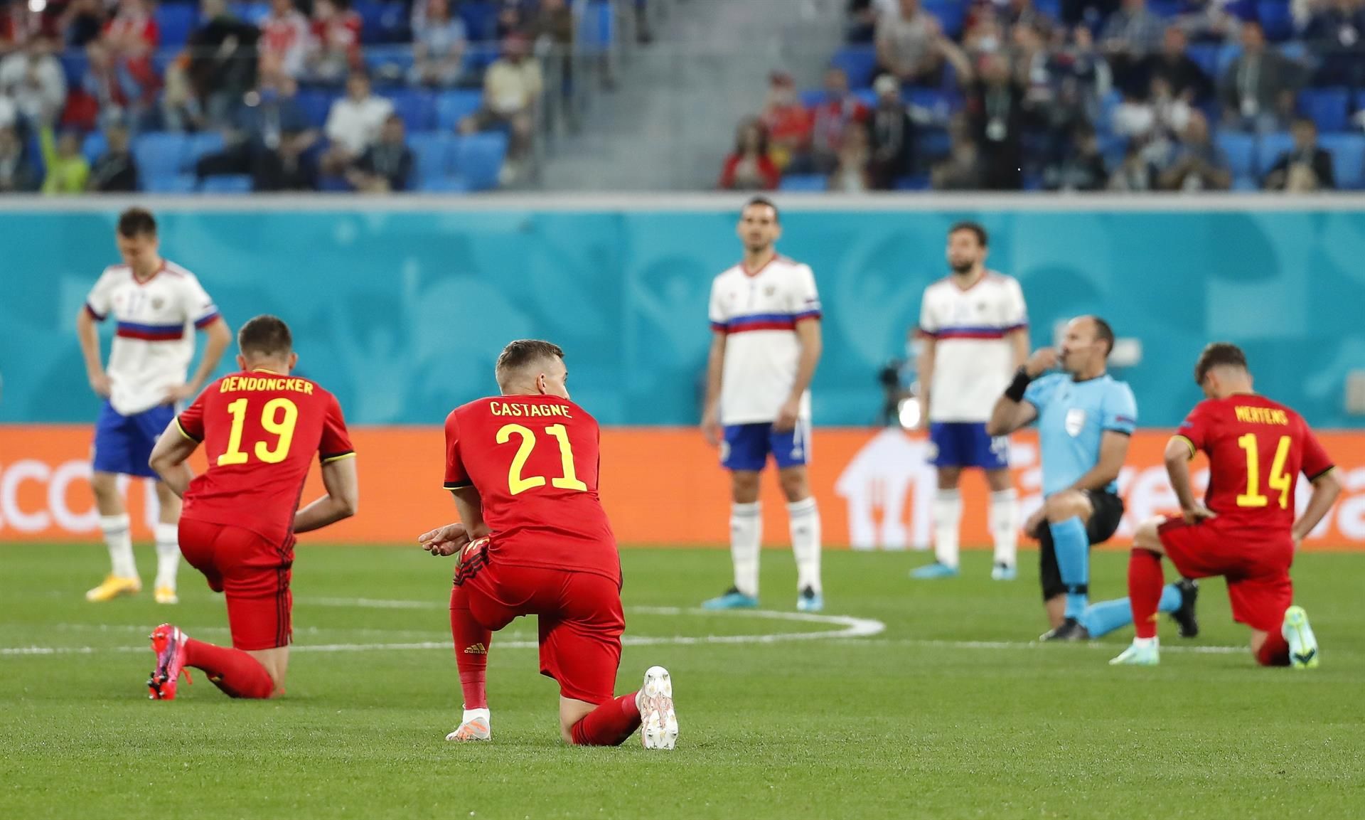 Los jugadores de Bélgica, arrodillados ante la mirada de los futbolistas rusos.