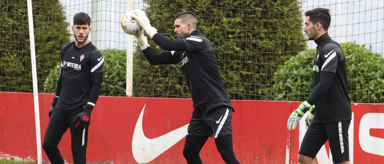 Cuéllar bloca el balón, entre Joel Jiménez y Diego Mariño, durante un entrenamiento. | Juan Plaza