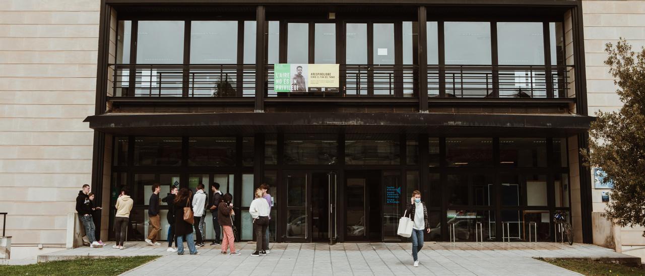 Varios estudiantes frente a un edificio de la UIB.