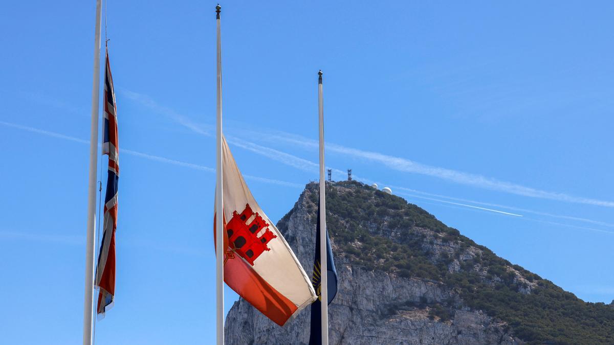 Flags of the Union Jack, Gibraltar and the Commonwealth wave at half mast in front of the Rock of Gibraltar following the death of Britain's Queen Elizabeth, in Gibraltar, September 9, 2022.