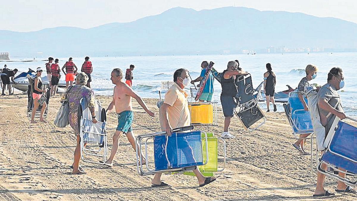 Imagen de archivo de bañistas desplegando sus sombrillas y sillas en Orpesa