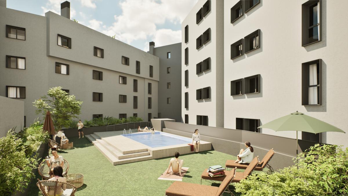 Piscina y zona verde comunitaria de las viviendas de obra nueva Quartus en el centro de Cuarte de Huerva.